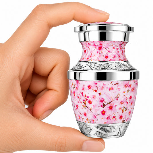 Pink Cherry Blossom Keepsake Cremation Urn held in hand with black velvet bag — small sharing memorial urn for women