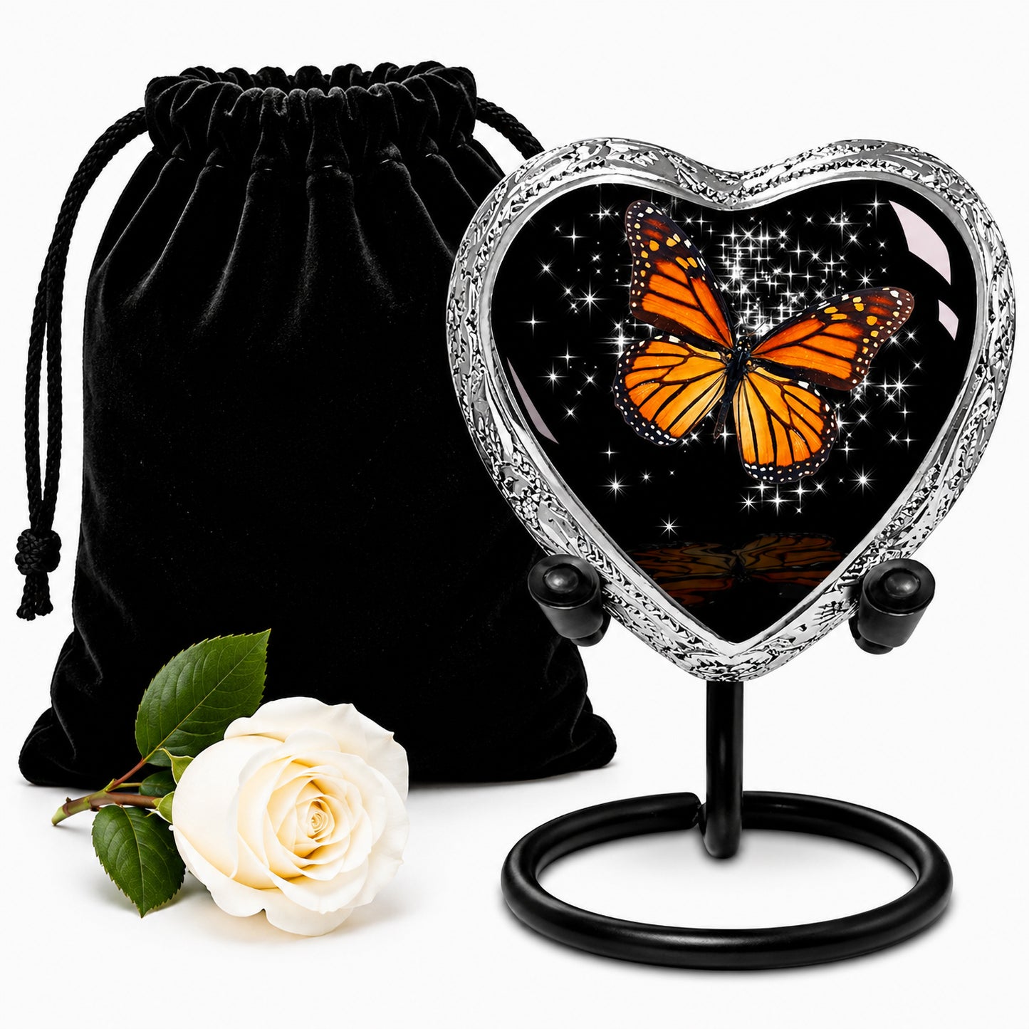 Black Monarch Butterfly Heart Keepsake Cremation Urn on display stand with black velvet bag and white rose — small sharing memorial urn for human ashes