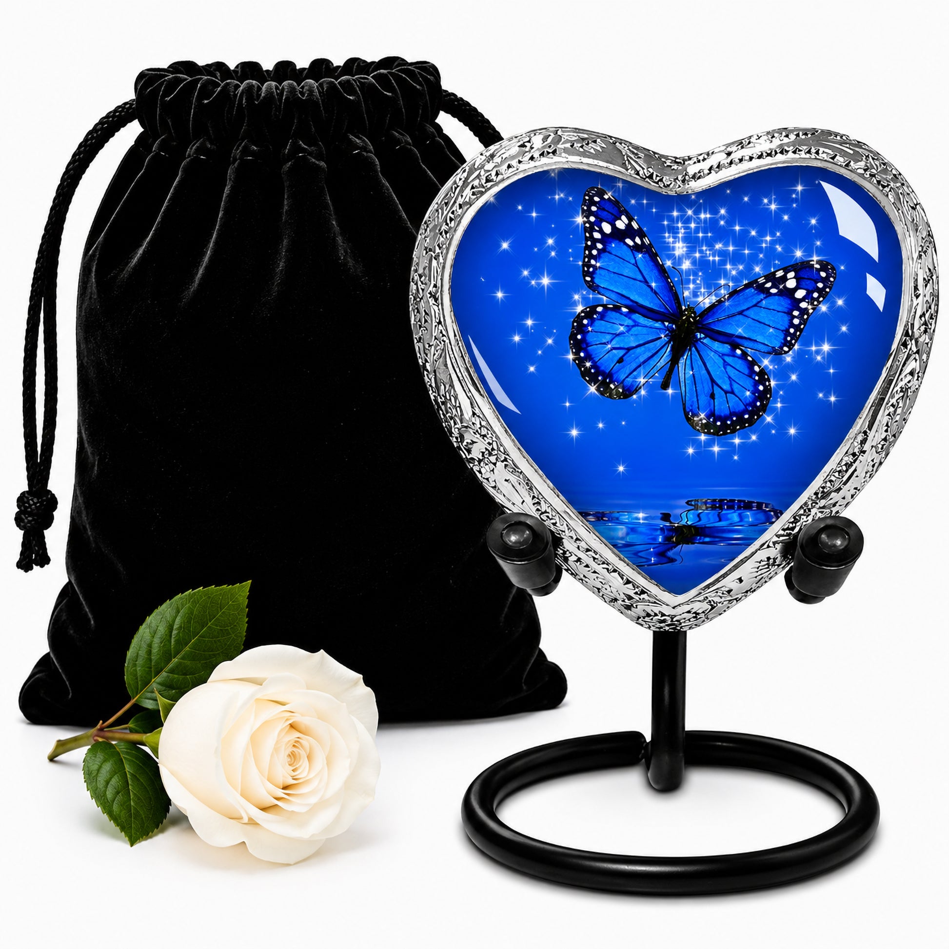Dark Blue Butterfly Heart Keepsake Cremation Urn on display stand with black velvet bag and white rose — small sharing memorial urn for human ashes