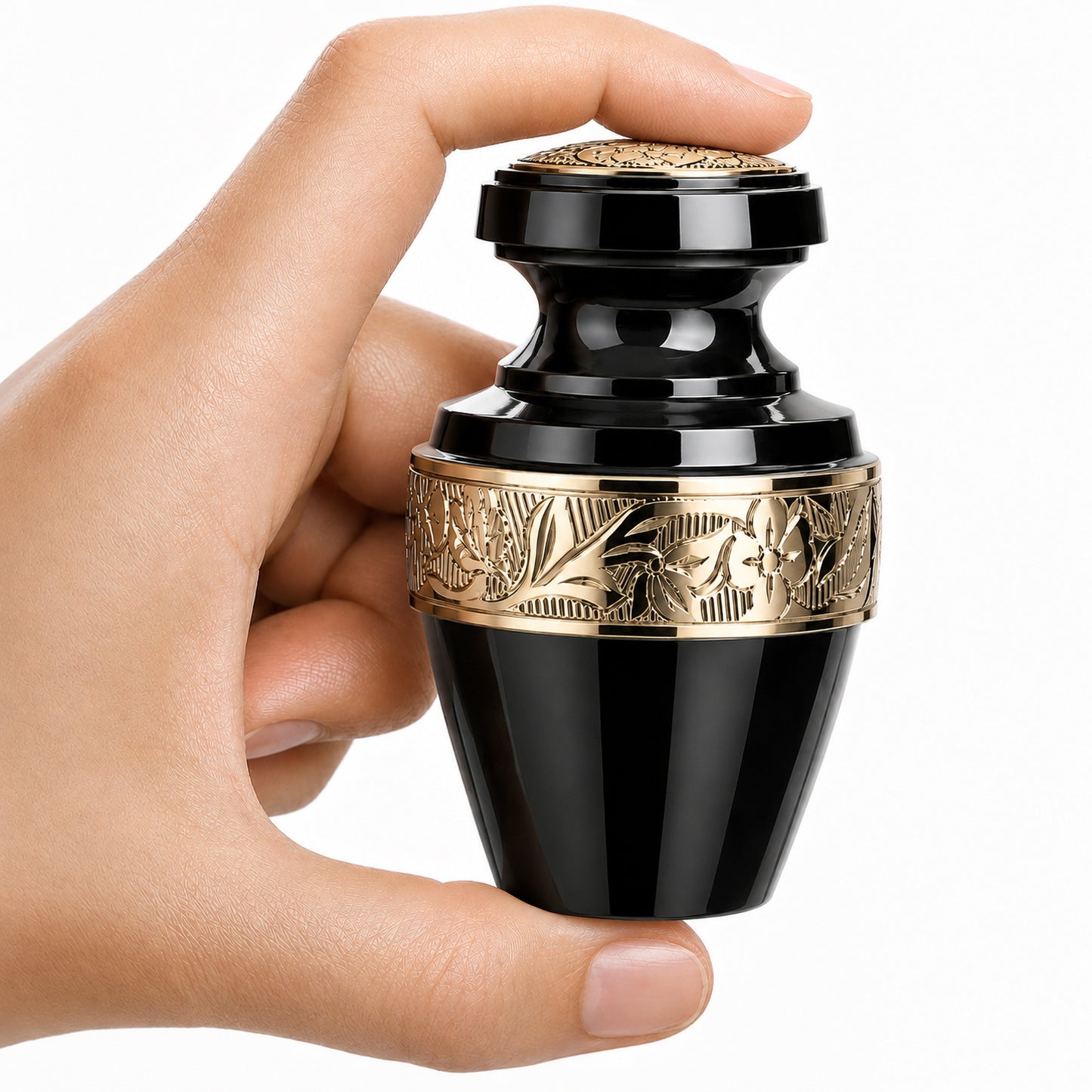 Classic Gloss Black Small Keepsake Cremation Urn — gloss black aluminum mini urn with gold floral banding held in hand on white background
