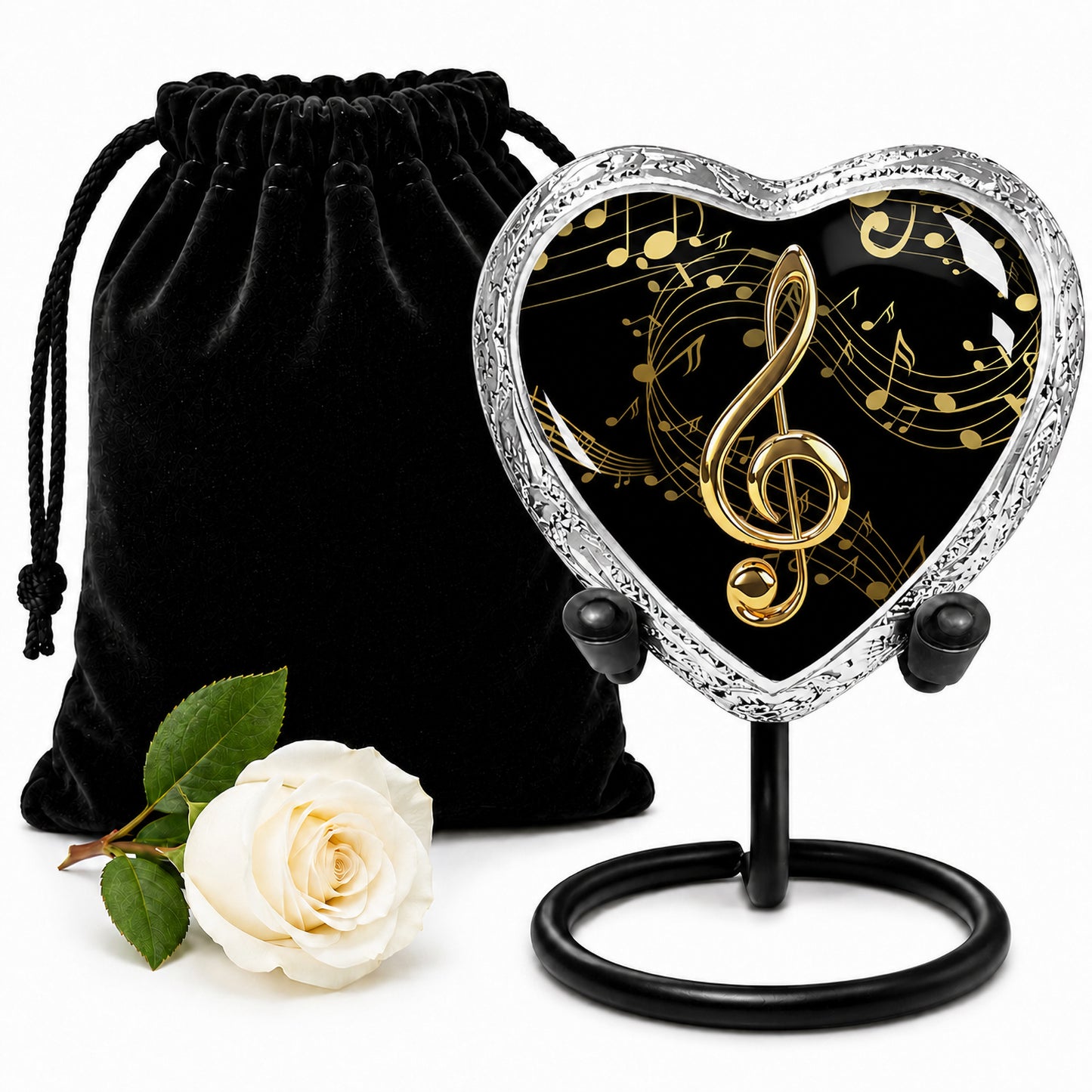 Black and gold musical notes heart keepsake urn with velvet bag and white rose on white background