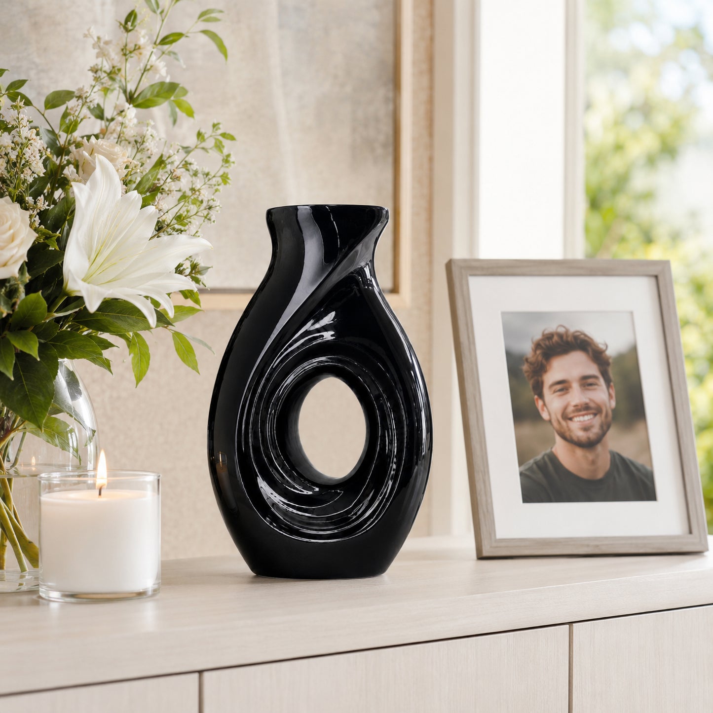 New Horizons Black urn on shelf with greenery and memorial books