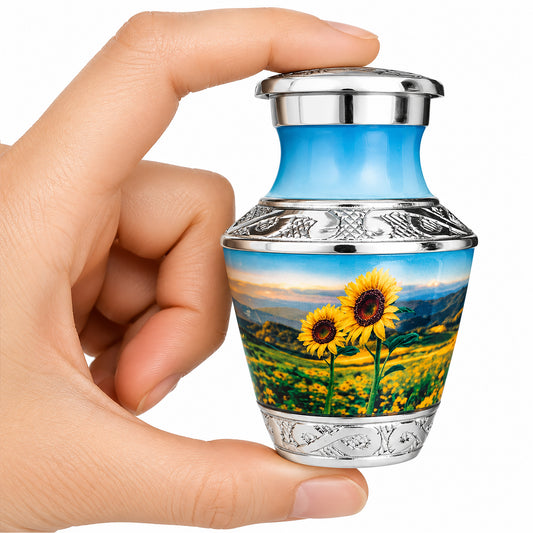 Sunflower Keepsake Cremation Urn held in hand with black velvet bag — small sharing memorial urn for human ashes