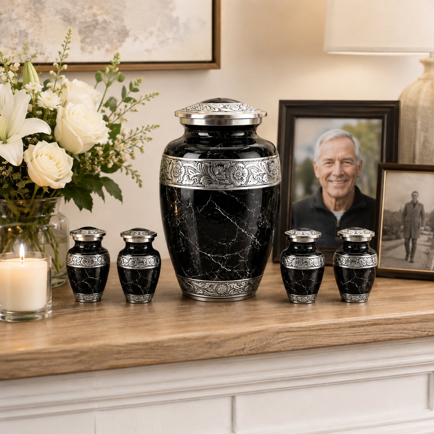 Black marble cremation urn set displayed on mantle with flowers and family photo