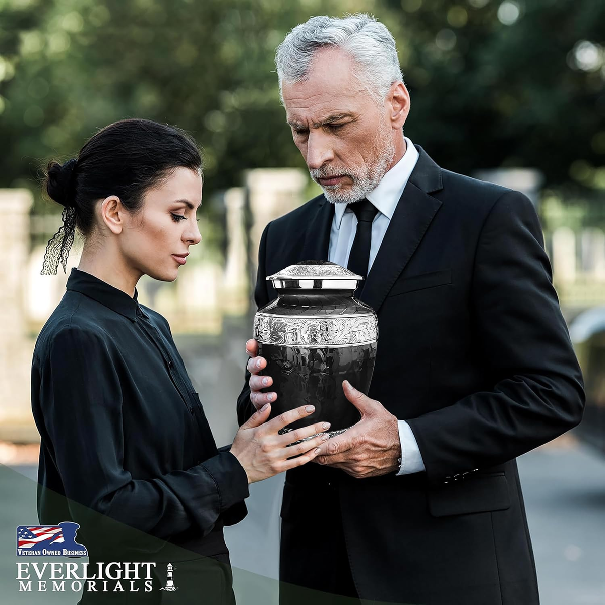 Black Forever After Adult Cremation Urn on wooden table beside framed photo of woman with white lilies and Forever in Our Hearts stone