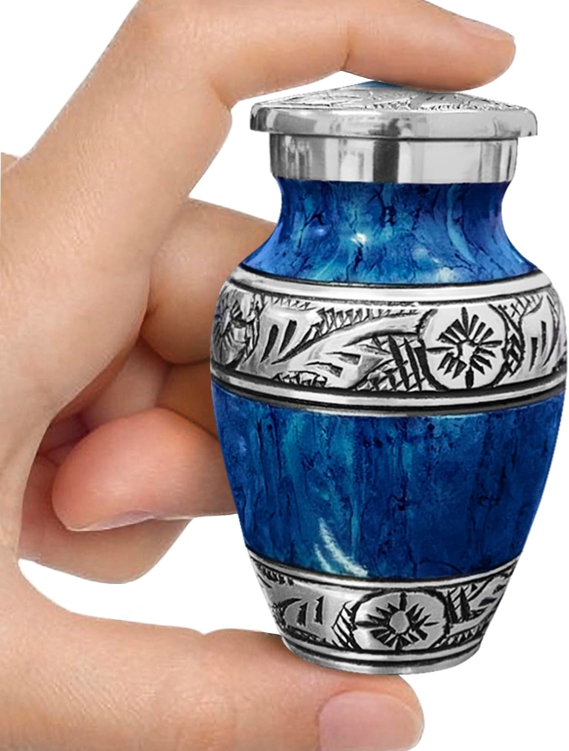Dark blue watercolor small keepsake cremation urn held between fingers showing size