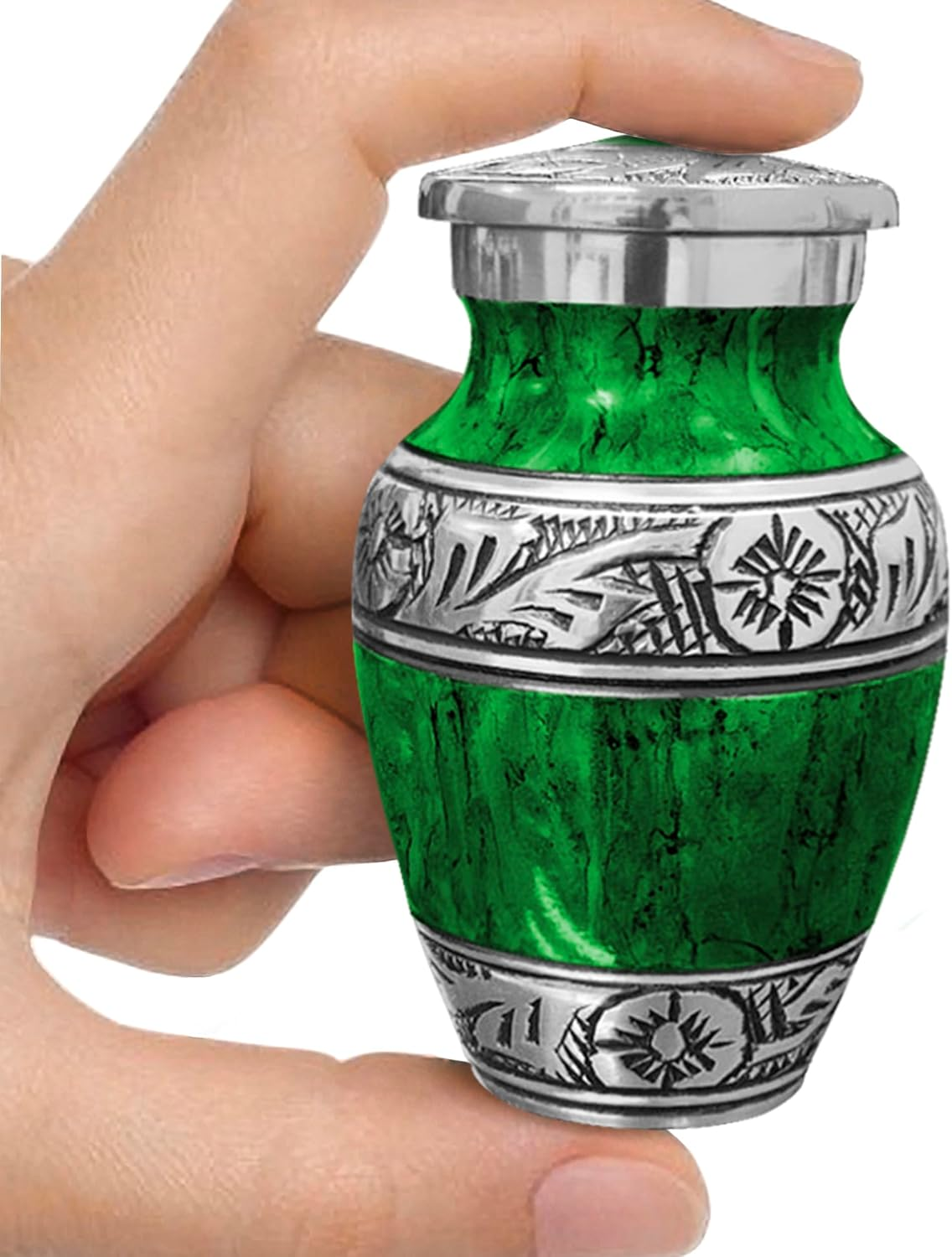 Green watercolor small keepsake cremation urn held between fingers showing size